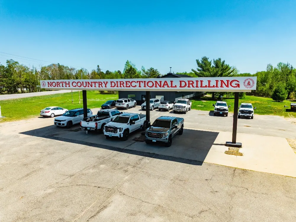 The North Country Directional Drilling office, with the company sign on a canopy and pickup trucks parked in front